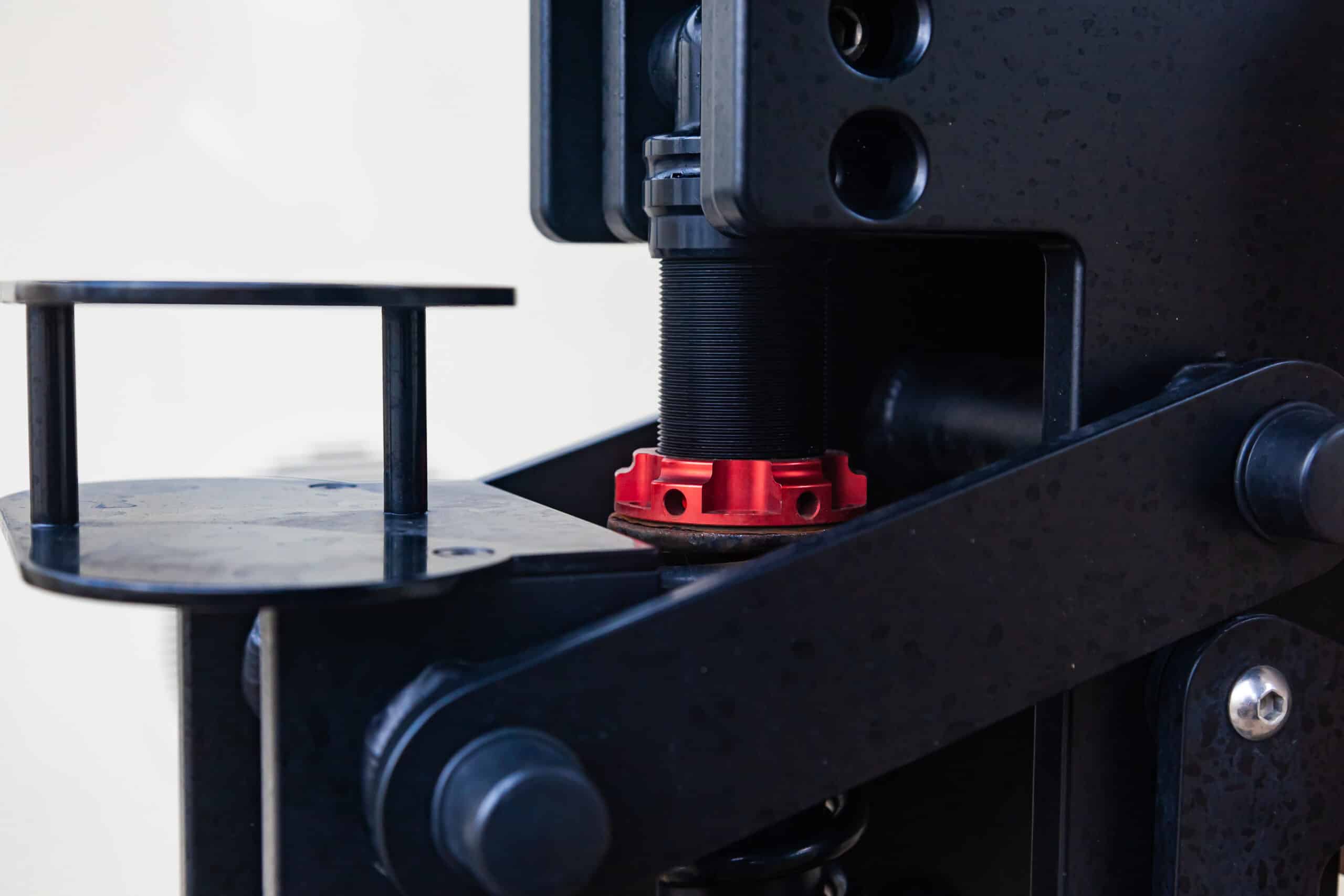 Steel mechanism with a threaded stem and clamping nut, representing a 3D printer's Z-axis lead screw