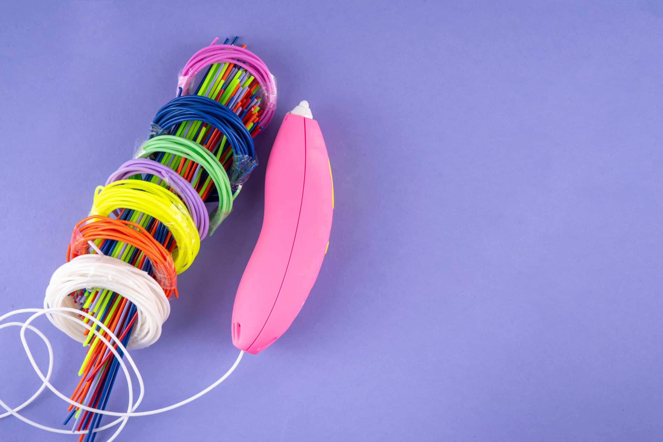 Colorful 3D printer filament spools of different plastic types