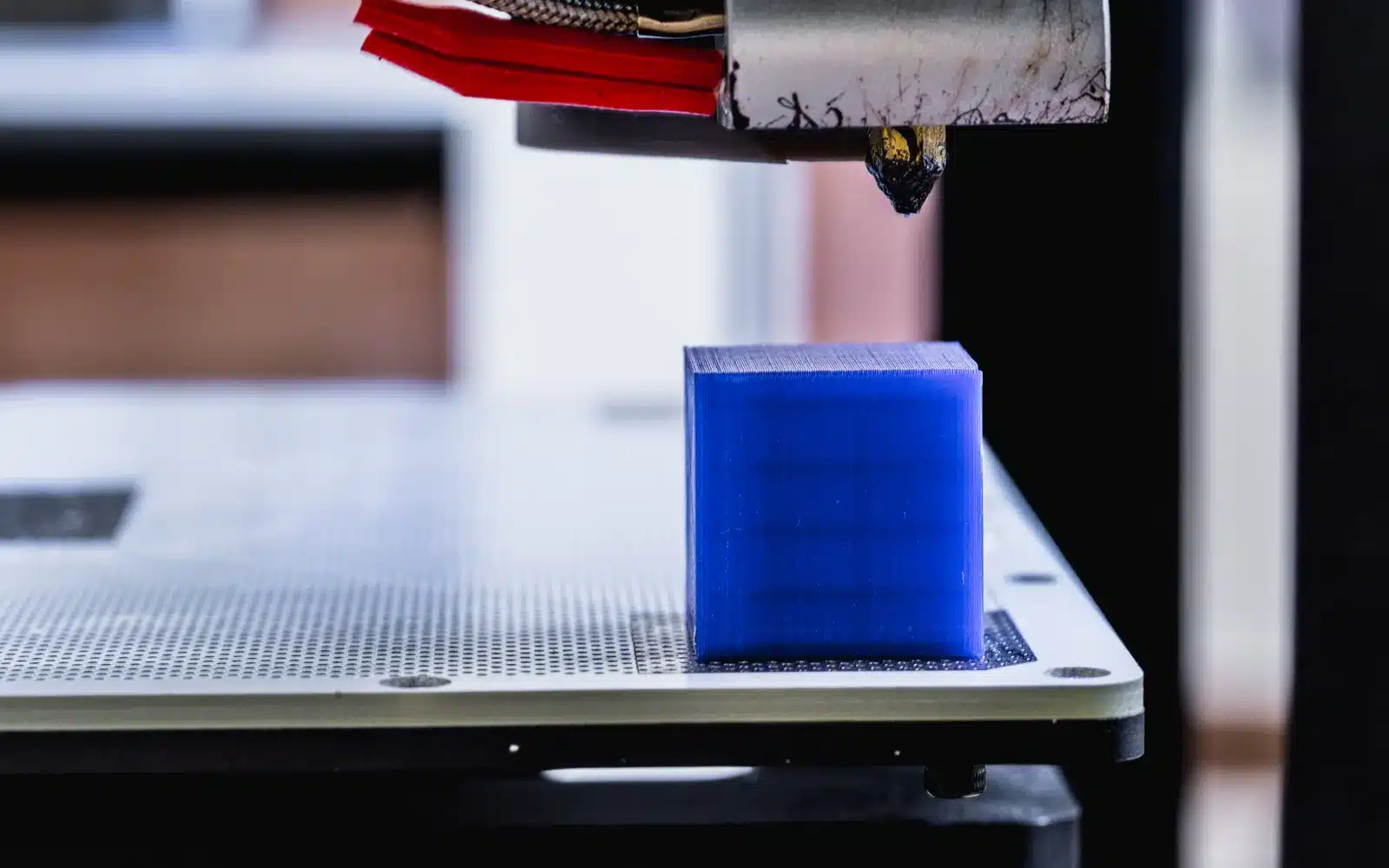 FDM print head moving over a partially printed object