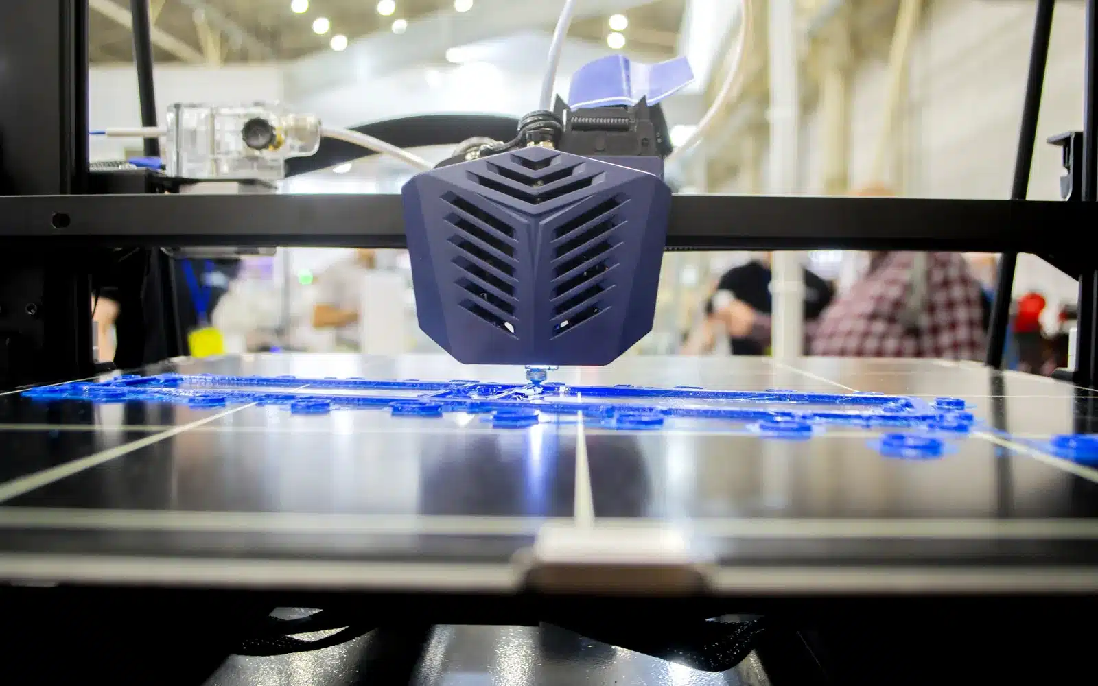 Close-up of a 3D printer nozzle extruding molten plastic