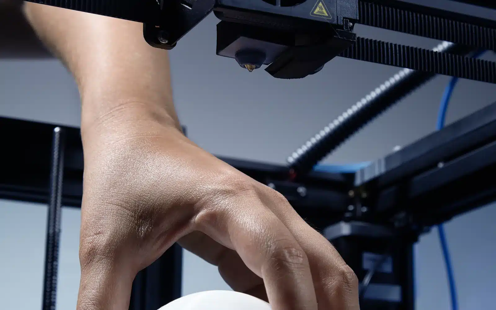 Hand lifting a complex 3D-printed object from its support structure