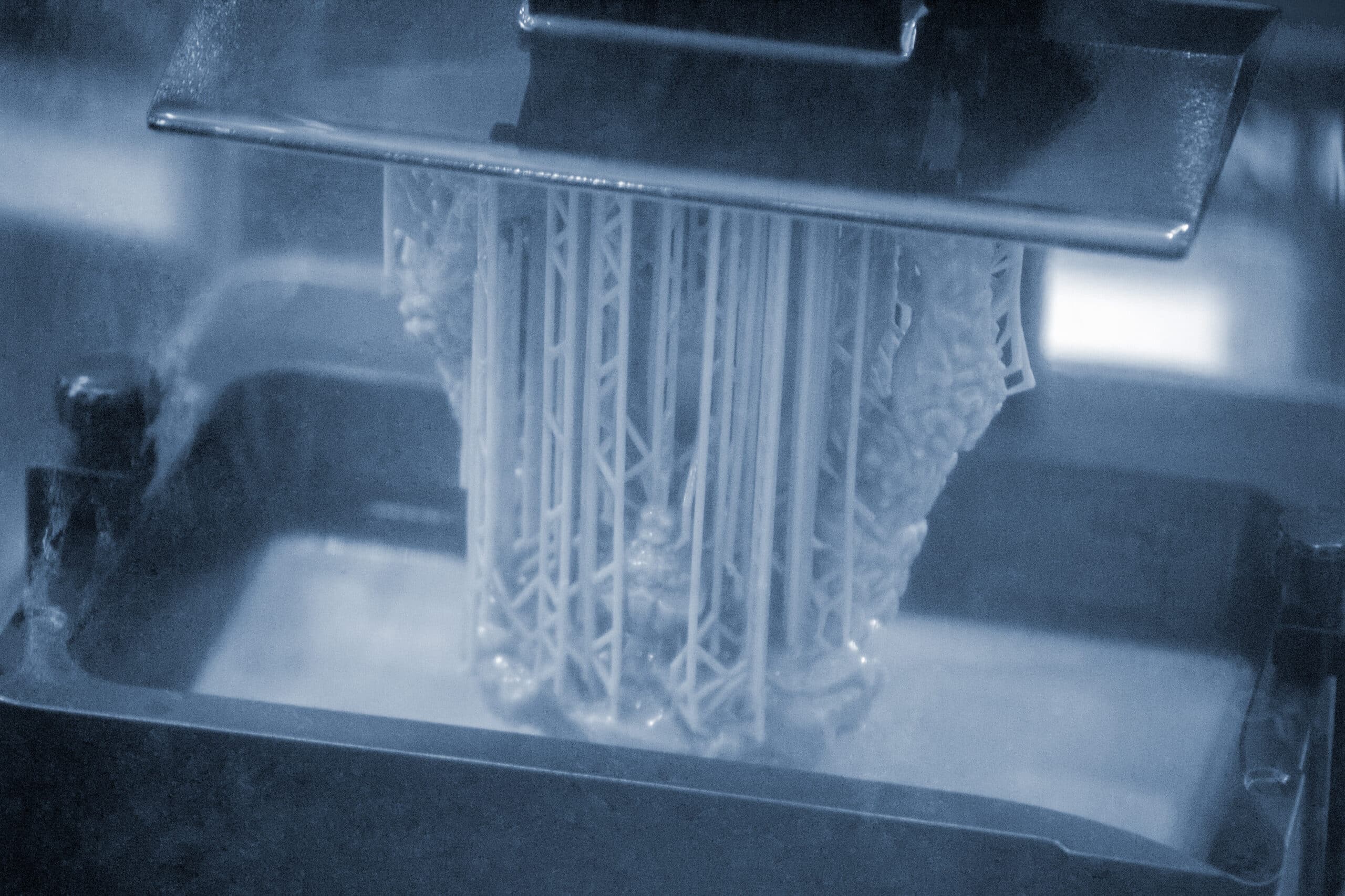 Close-up of a resin SLA 3D printer in operation; generic printer hardware shown, not a screenshot of slicing software