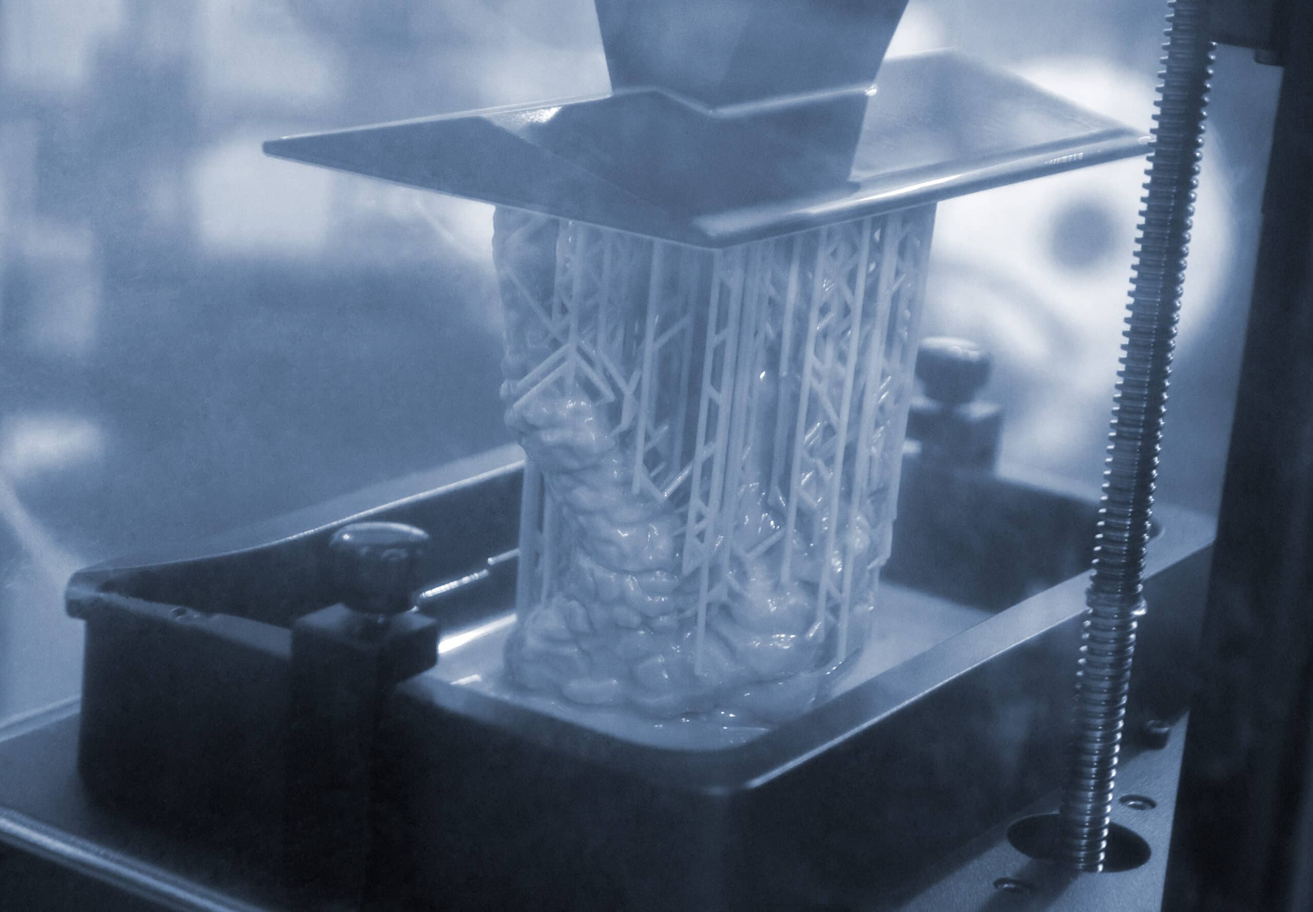 Close-up of a resin SLA 3D printer in operation; generic printer hardware shown, not a screenshot of an error display