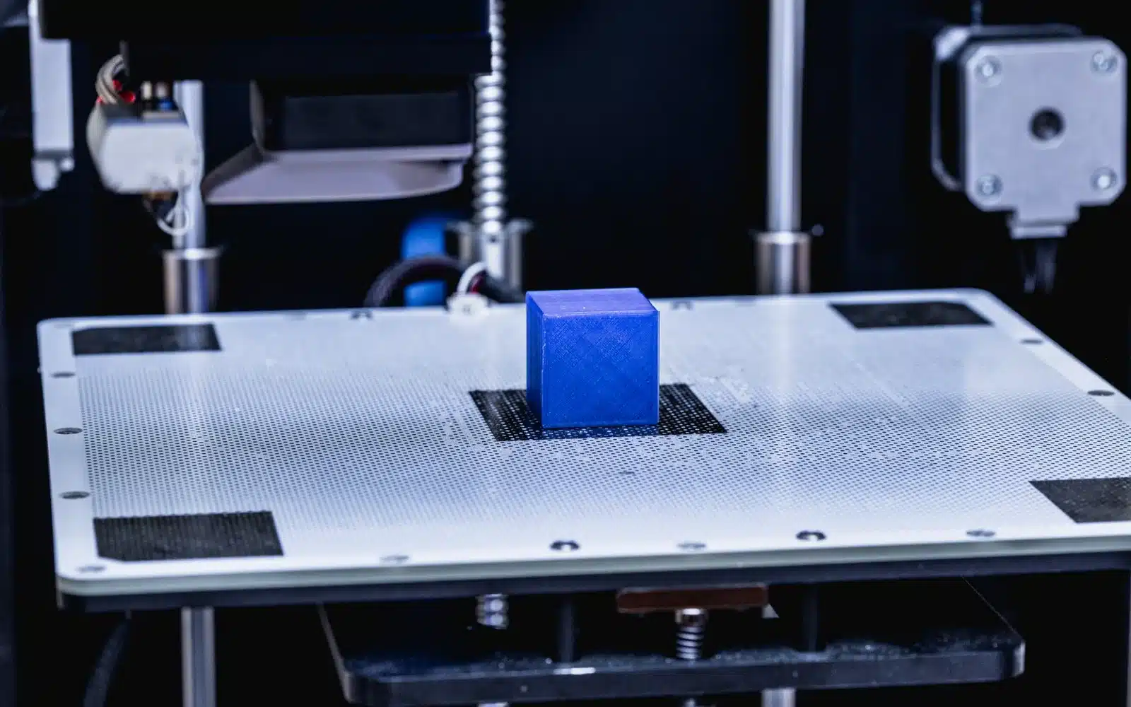 Close-up of a 3D printer head and nozzle in action