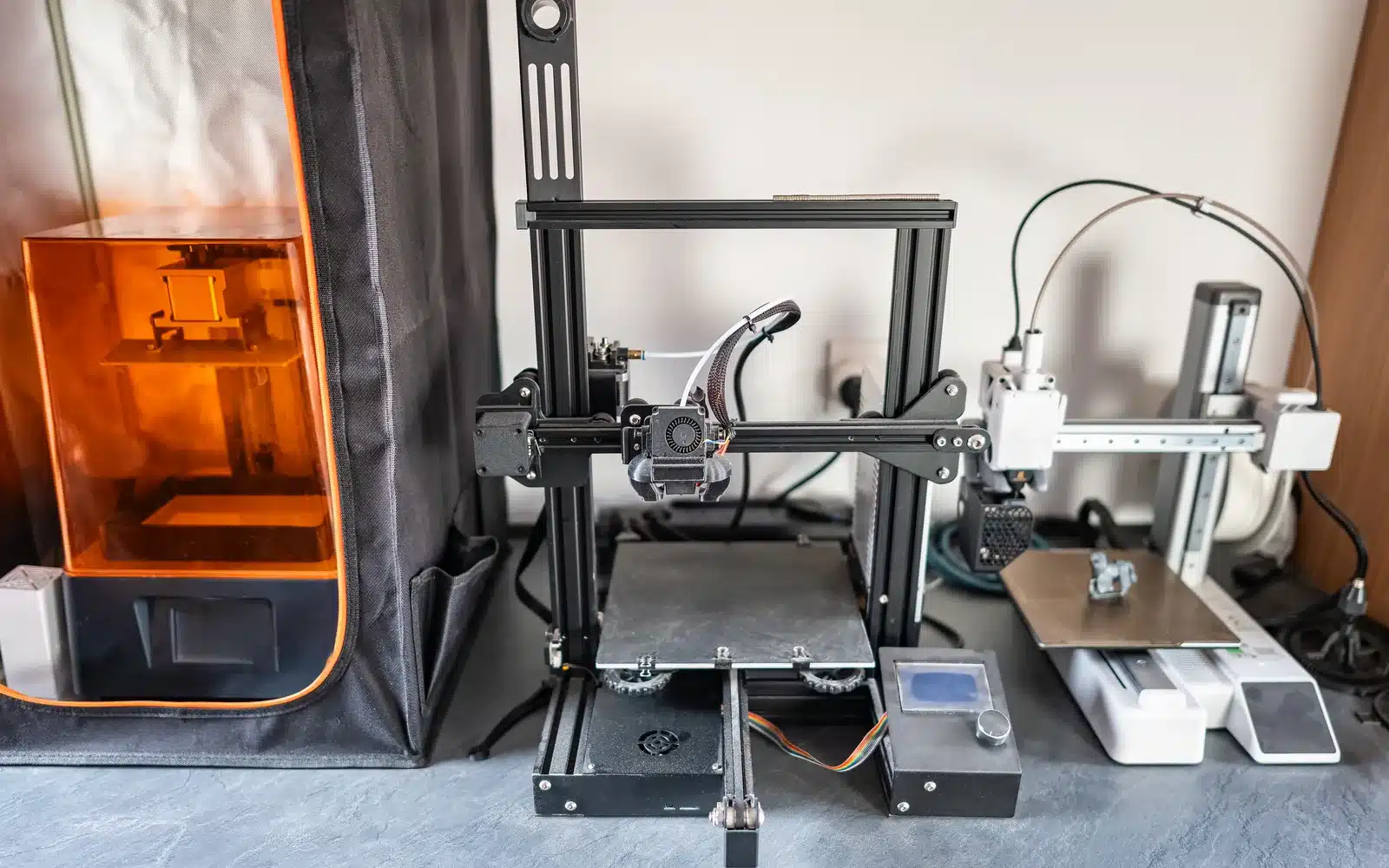 Different 3D printer models creating small plastic and resin designs