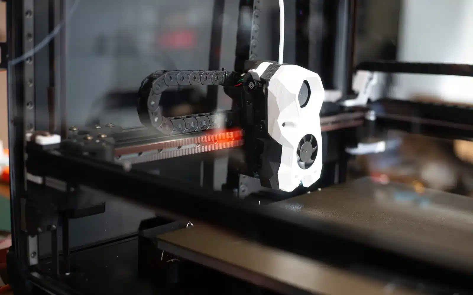 Modern 3D printer extruder depositing filament