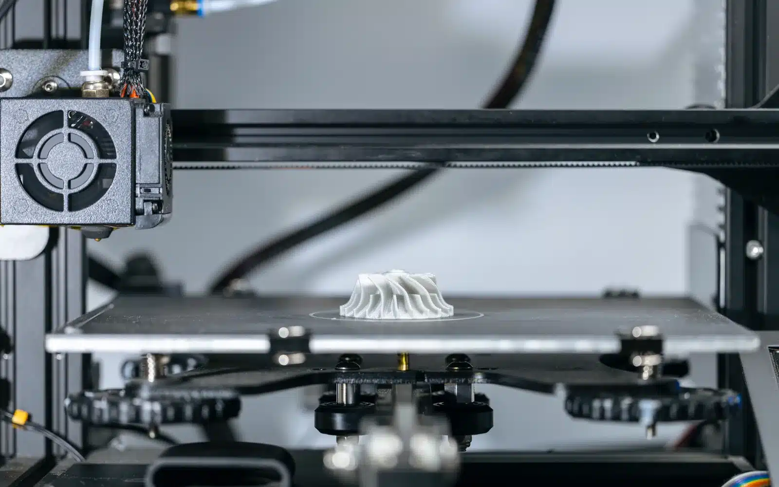Modern 3D printer producing a detailed plastic part