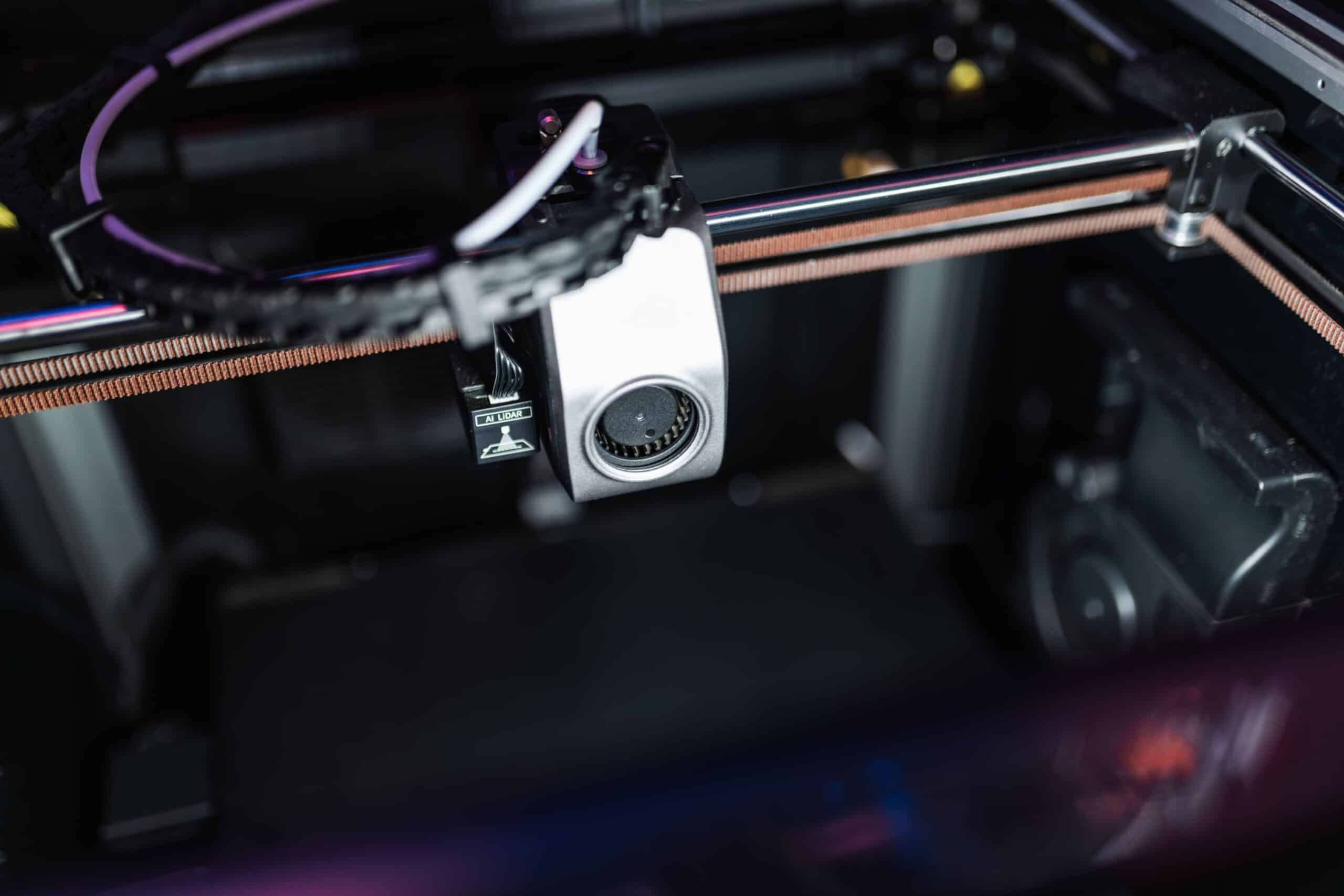 Detailed image showcasing the intricate components of a high-tech 3D printer in action