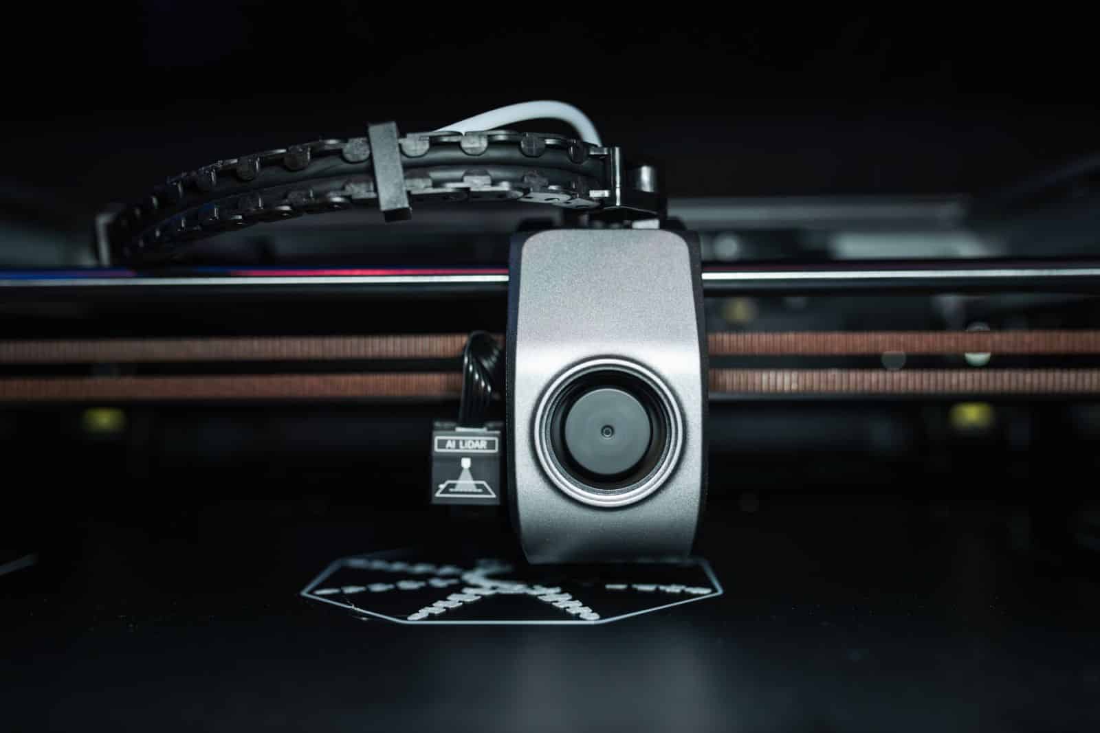 Detailed close-up of a 3D printer extrusion head in focus
