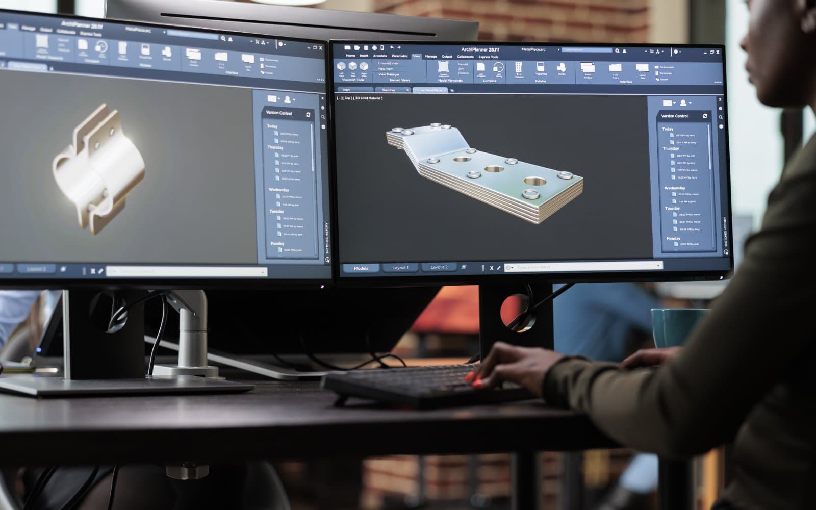 A person working on 3D modeling software on a computer screen.