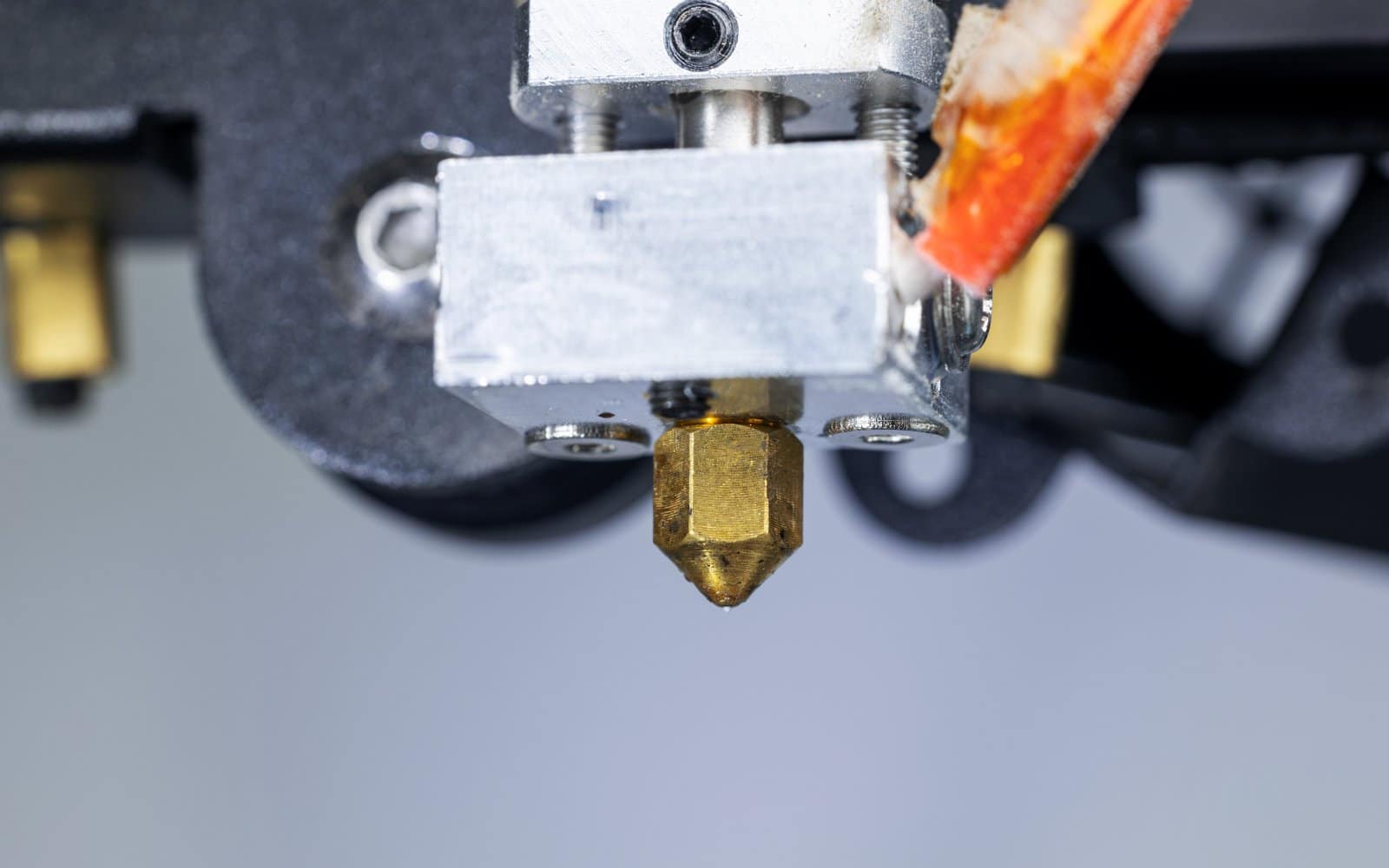 Close-up of a 3D printer's hotend and extruder assembly.