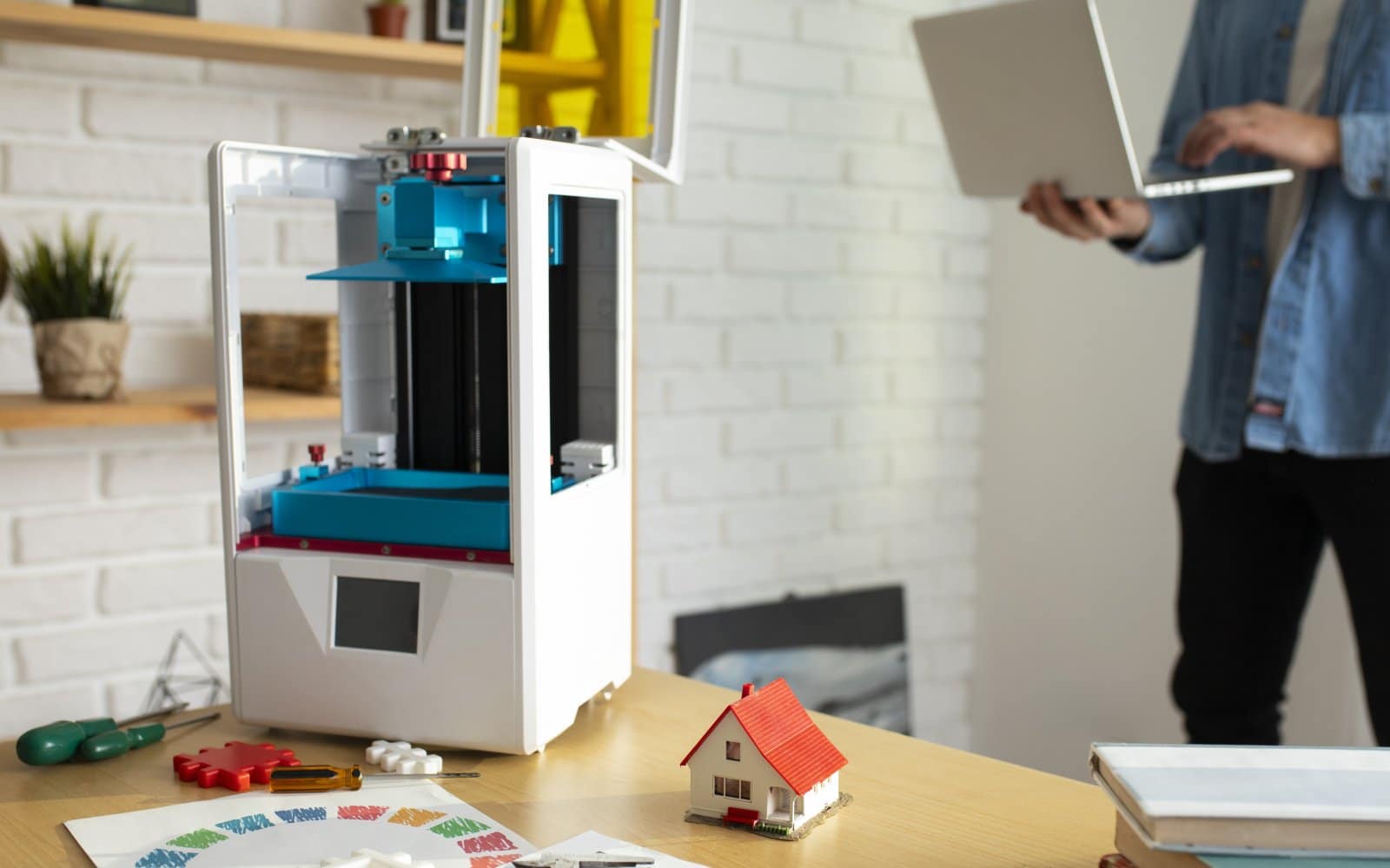 Freshly unboxed FDM 3D printer set up on a workbench, ready for first-time configuration.
