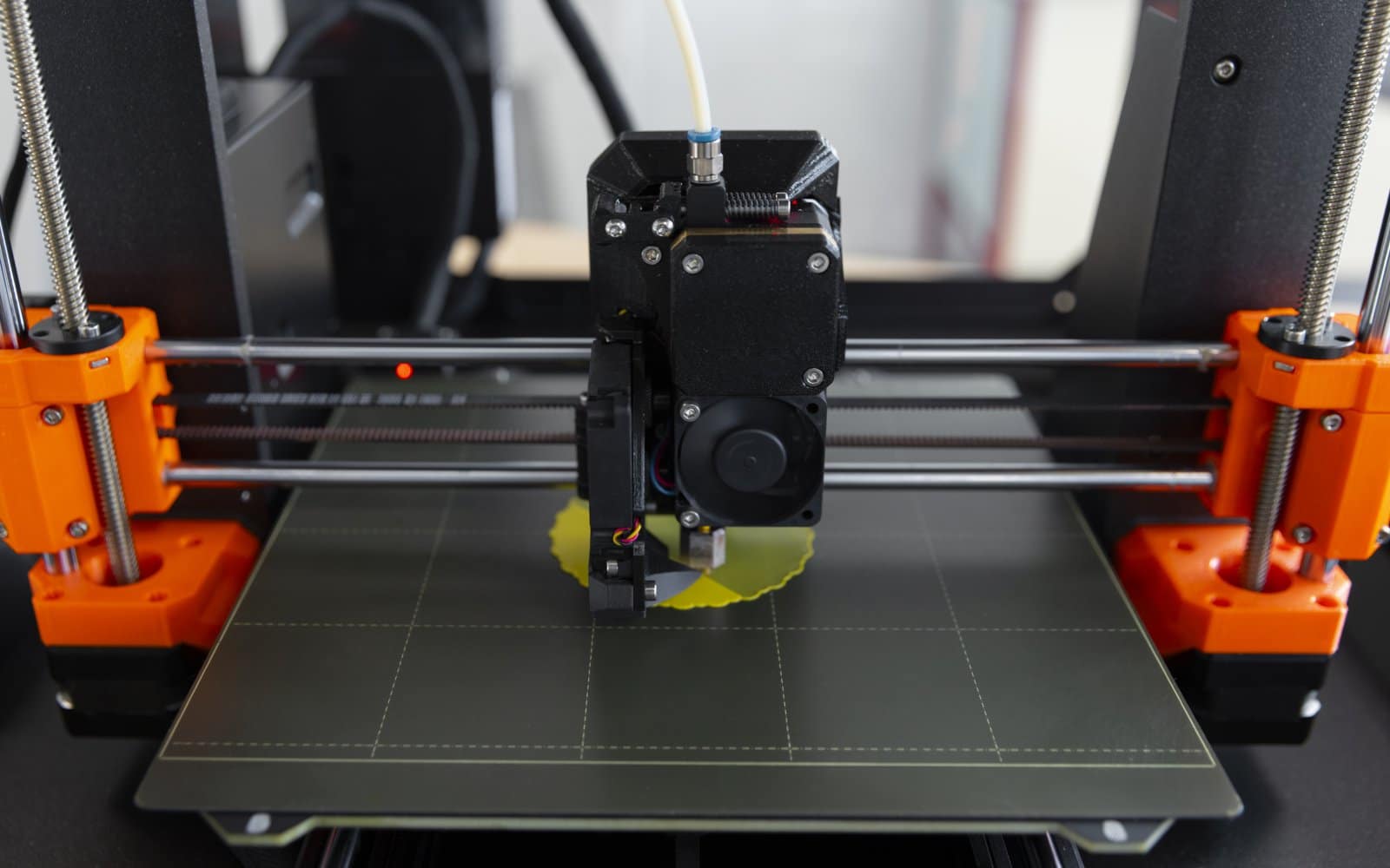 Close-up view of a 3D printer's extruder and nozzle area, relevant to nozzle inspection and replacement.