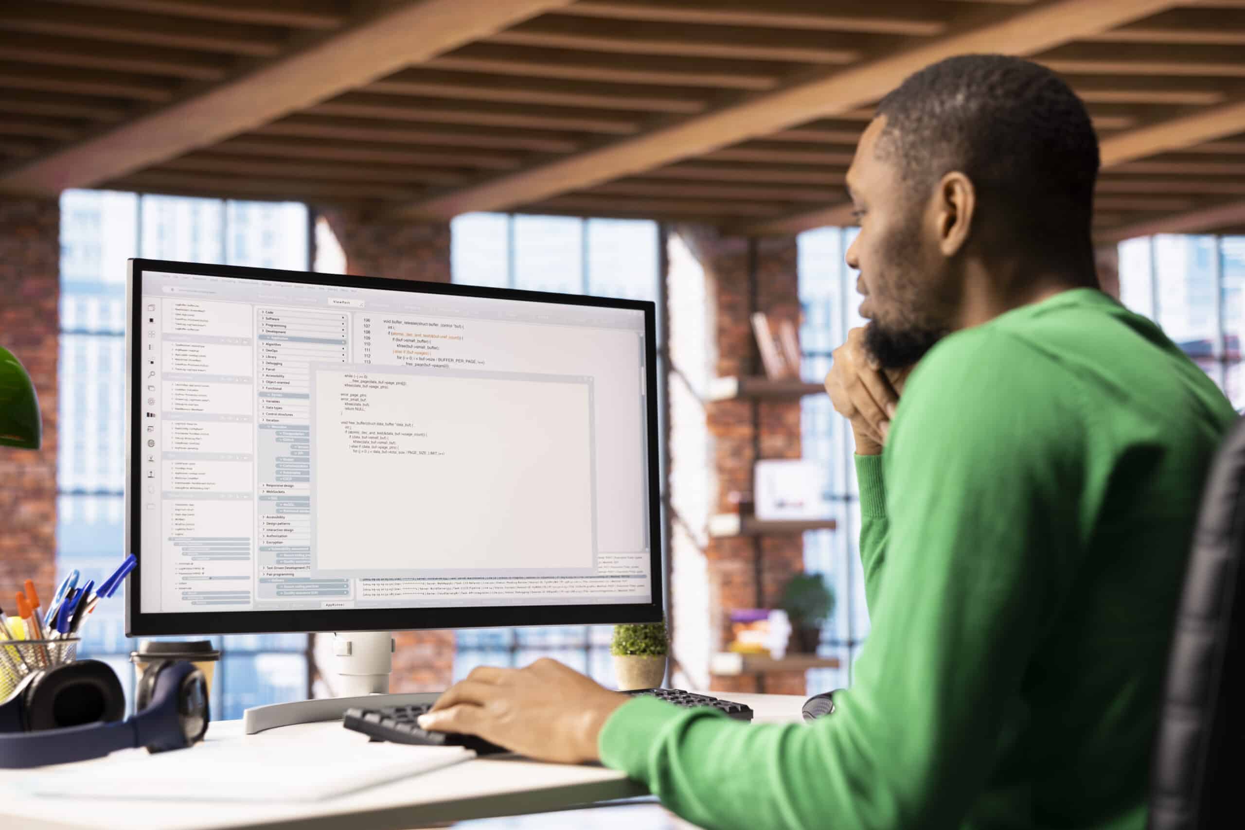 A developer typing code at a desktop computer and running a script, illustrating OrcaSlicer's new Python plugin system