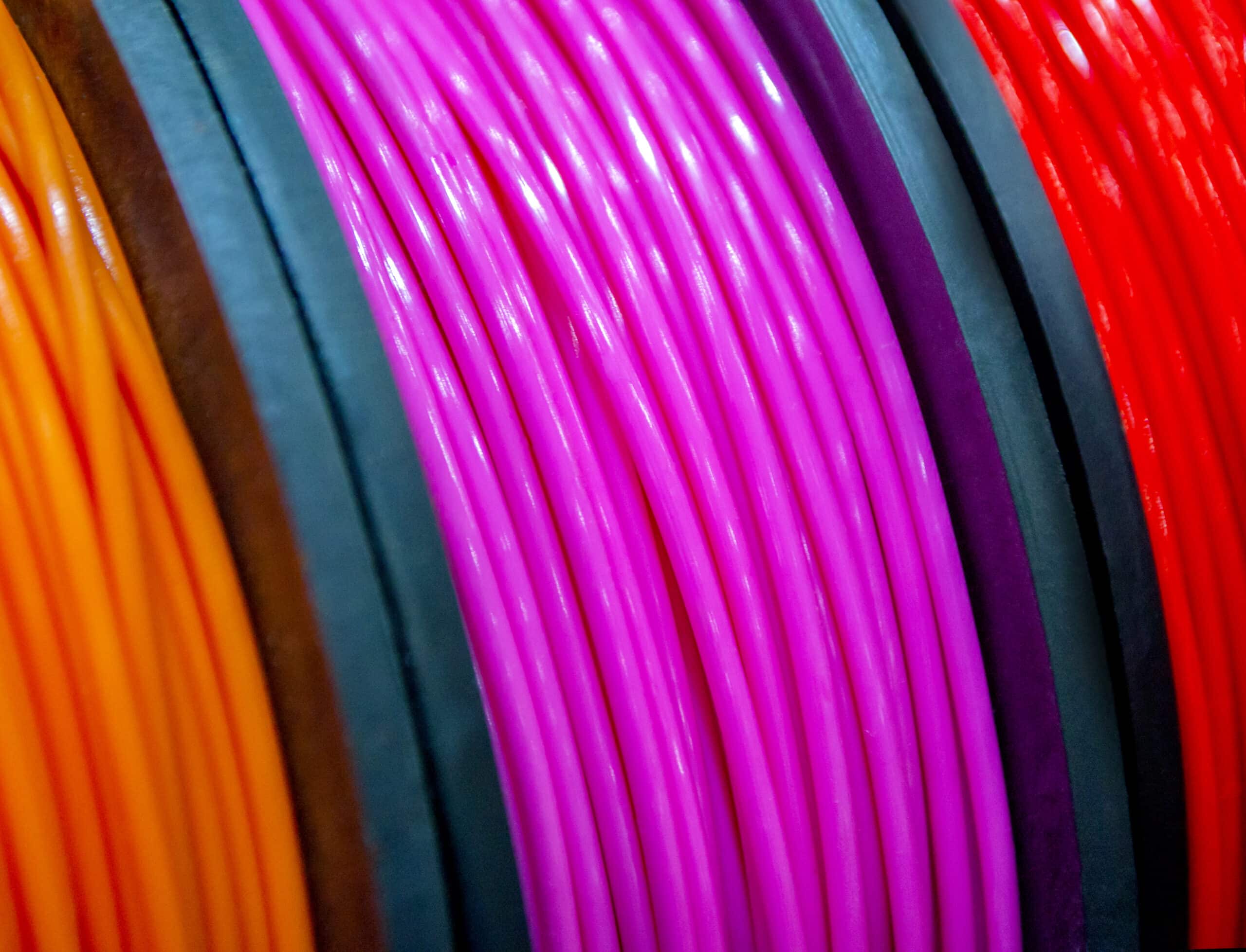 Multicolored 3D printer filament spools close-up