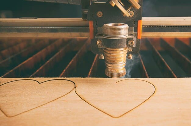 A laser cutting machine burning a heart-shaped pattern into a wooden plank, with smoke rising from the cut